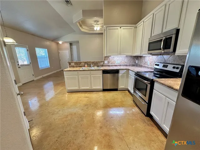 a view of a kitchen with a sink and cabinets