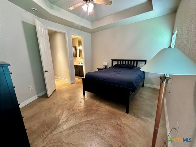 a bedroom with a bed and a lamp