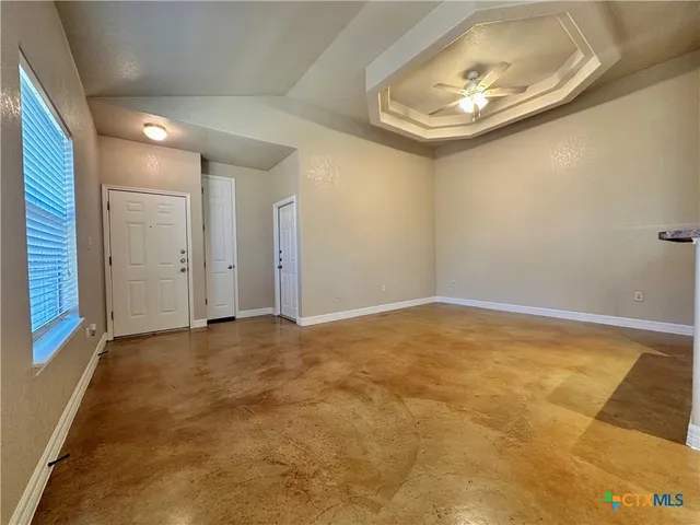 an empty room with closet and a chandelier fan