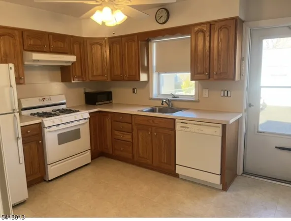 a kitchen with a stove sink and cabinets