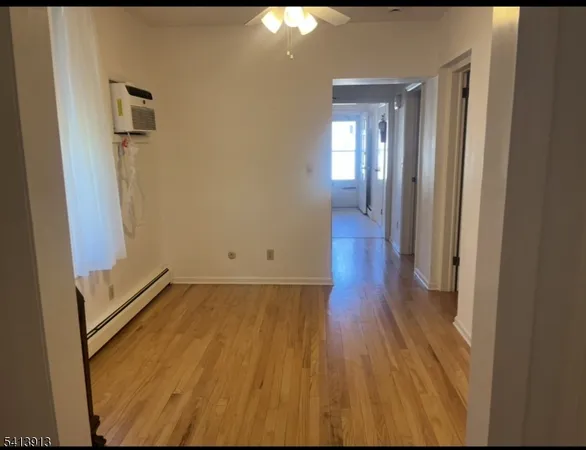 a view of a hallway with wooden floor