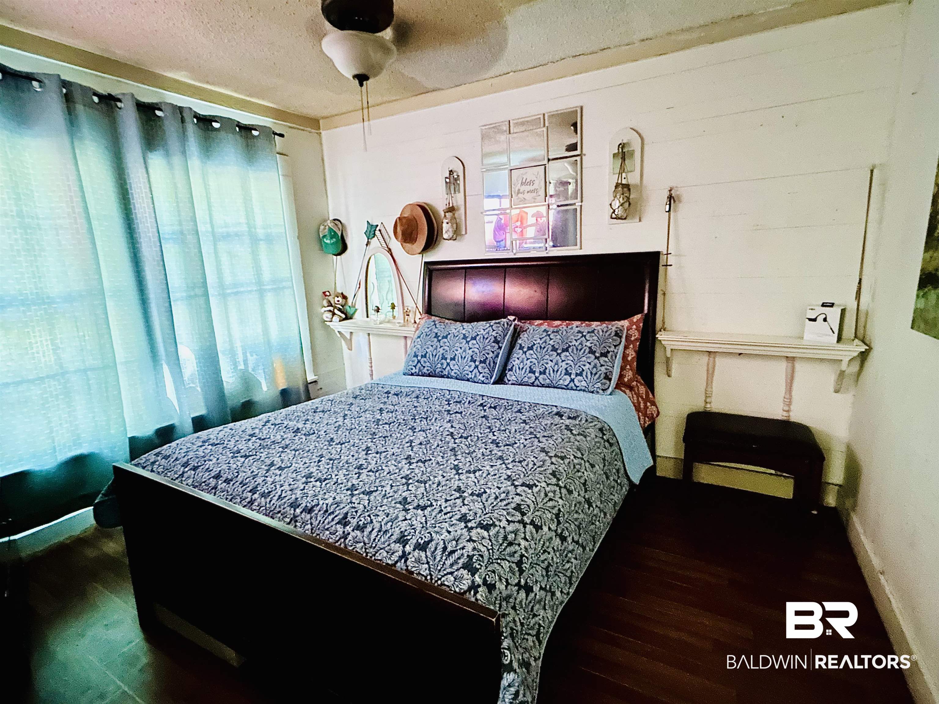 722 Conoley Avenue Brewton, AL 36426 - Photo 5 of 7 Bedroom with dark wood finished floors, a ceiling fan, and a textured ceiling