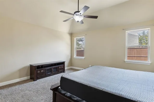 a view of a room with wooden floor and windows