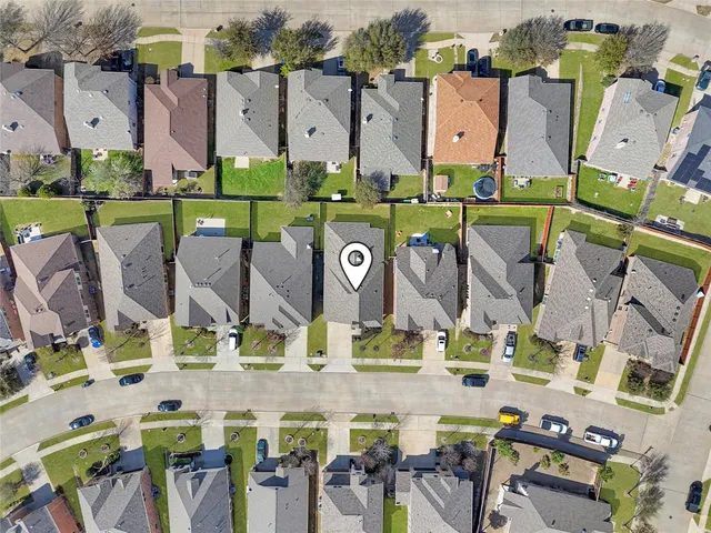 an aerial view of a house with outdoor space