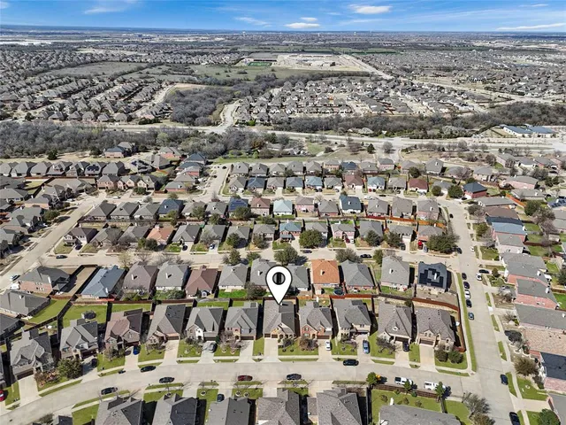 an aerial view of multiple houses with yard
