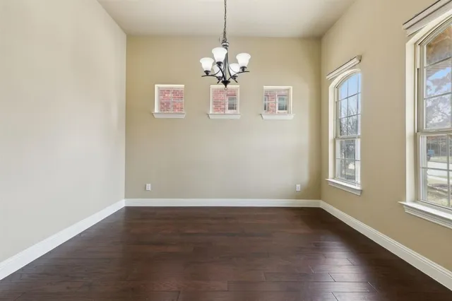a front view of a house with a garden and yard
