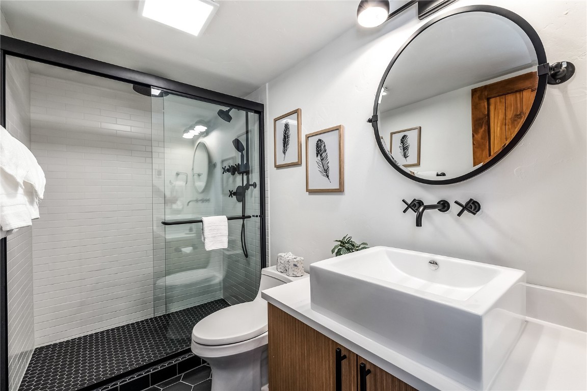 800 Columbine Road, Unit 5 Breckenridge, CO 80424 - Photo 24 of 38 a bathroom with a sink toilet and a mirror
