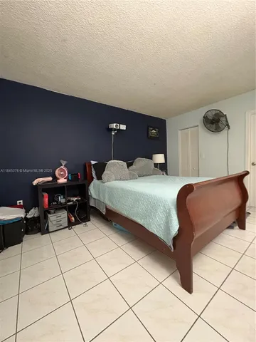 a bedroom with a bed and a table