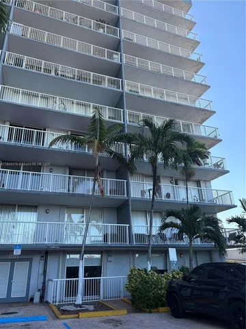 a front view of a building with balcony and outdoor space
