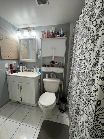 a bathroom with a sink toilet and a mirror