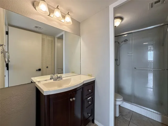 a bathroom with a sink double vanity and a mirror