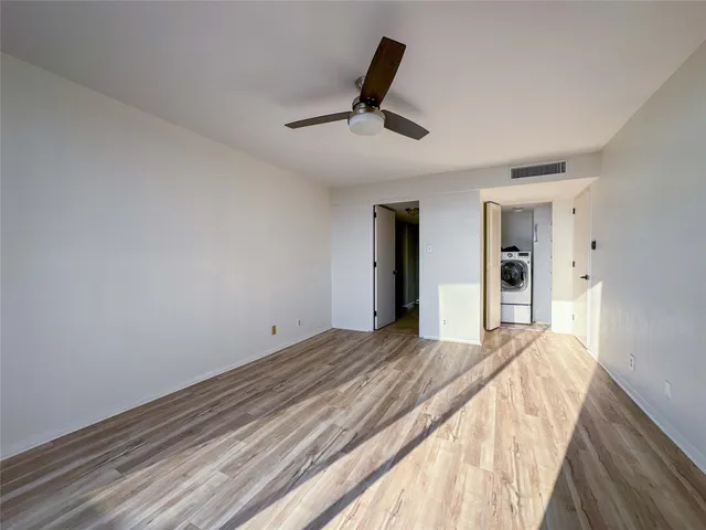 a bedroom with a bed and a ceiling fan