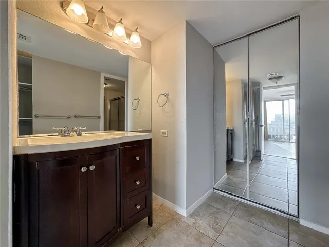 a bathroom with a sink vanity and a mirror