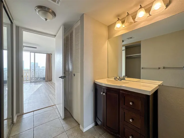 a bathroom with a granite countertop sink and a mirror