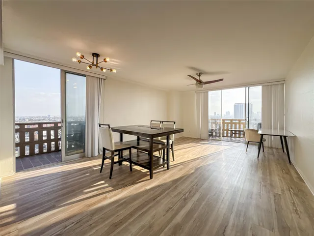 a view of a room with furniture and wooden floor