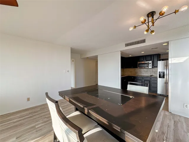 a view of a dining room with a table and chairs