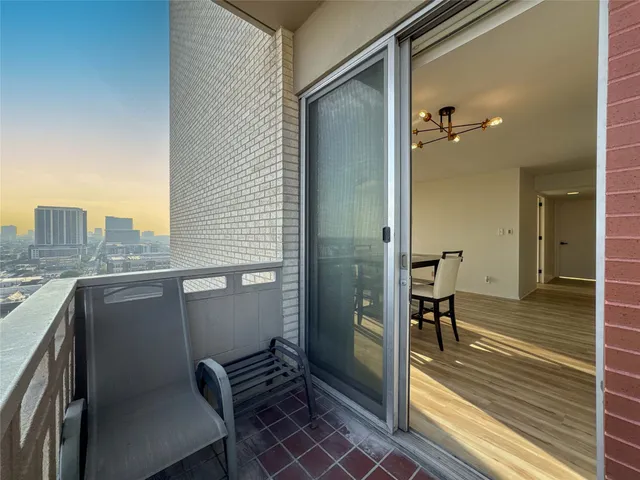 a view of a balcony with chair and table