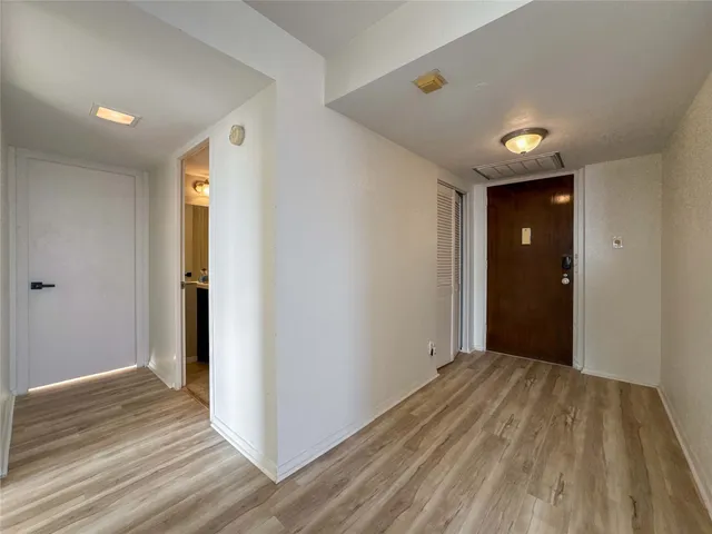 a view of hallway with wooden floor
