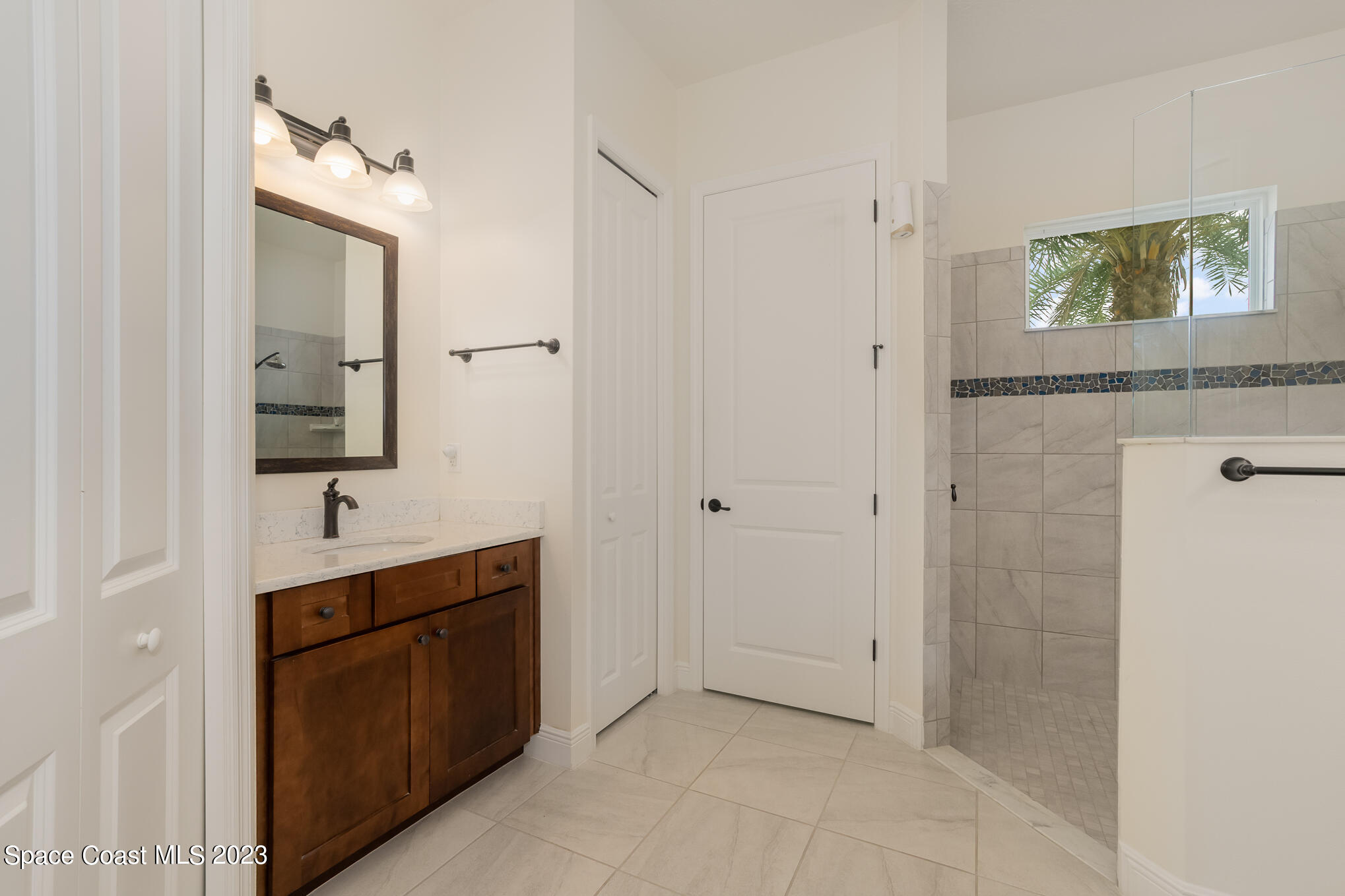 448 Lorelei Avenue Melbourne, FL 32901 - Photo 12 of 31 a bathroom with a sink and a mirror