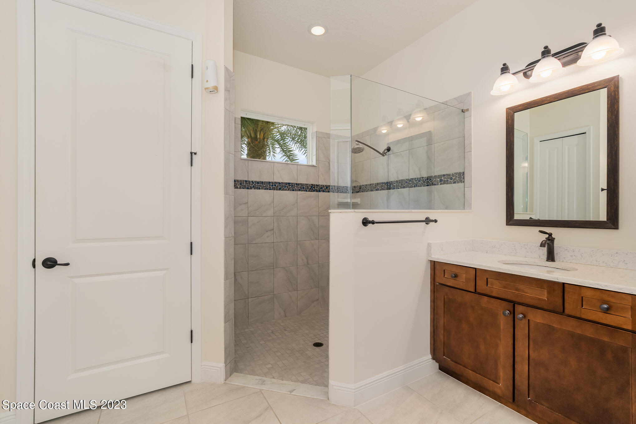 448 Lorelei Avenue Melbourne, FL 32901 - Photo 13 of 31 a bathroom with a shower sink and mirror
