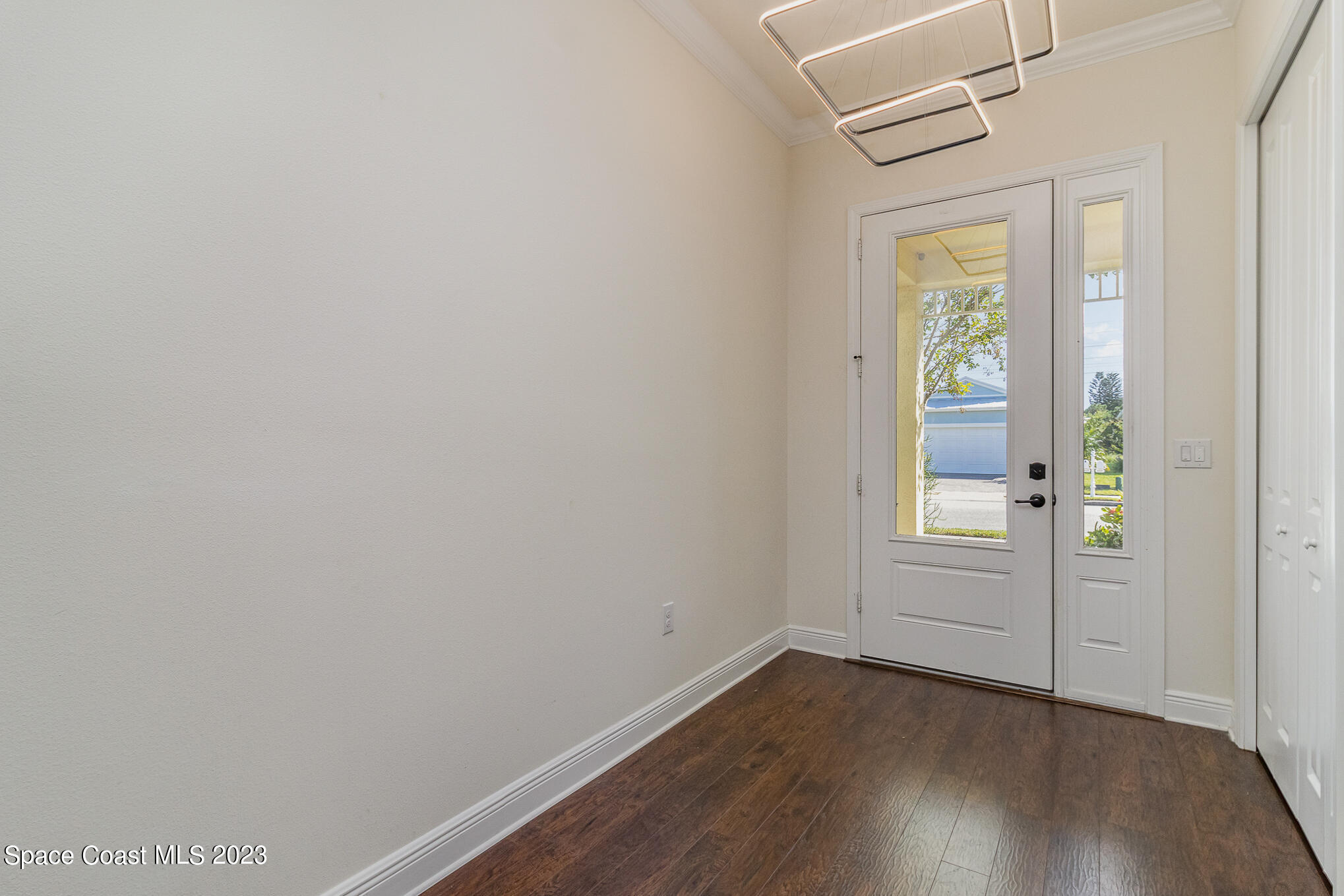 448 Lorelei Avenue Melbourne, FL 32901 - Photo 21 of 31 an empty room with wooden floor and windows