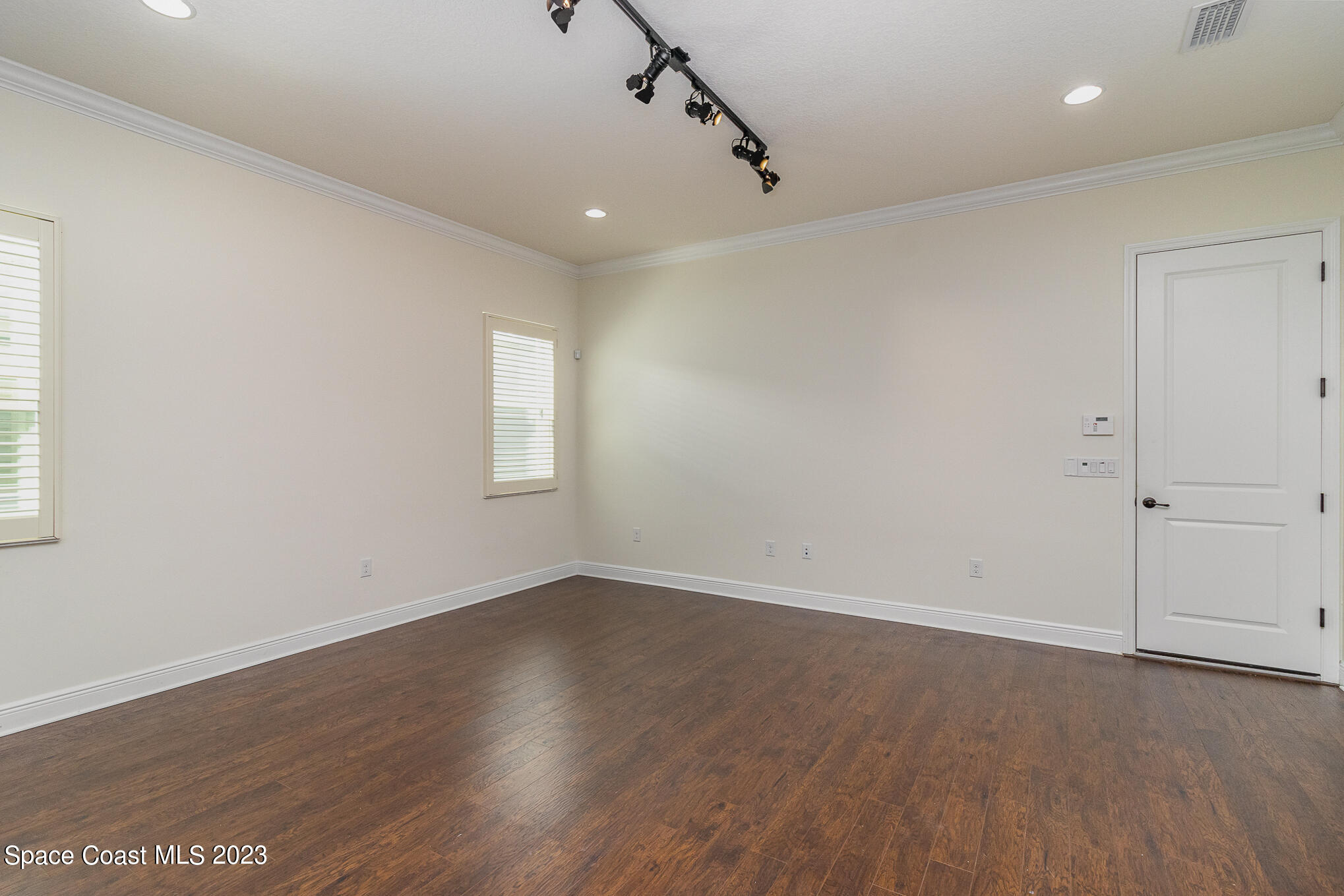 448 Lorelei Avenue Melbourne, FL 32901 - Photo 7 of 31 an empty room with wooden floor and windows