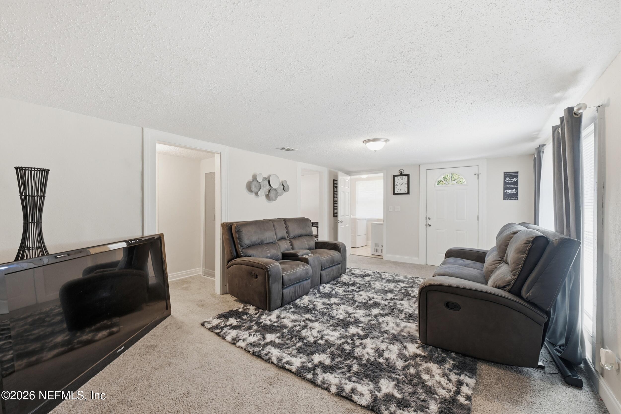 760 Westbrook Road Jacksonville, FL 32209 - Photo 3 of 11 a living room with furniture a couch and a flat screen tv