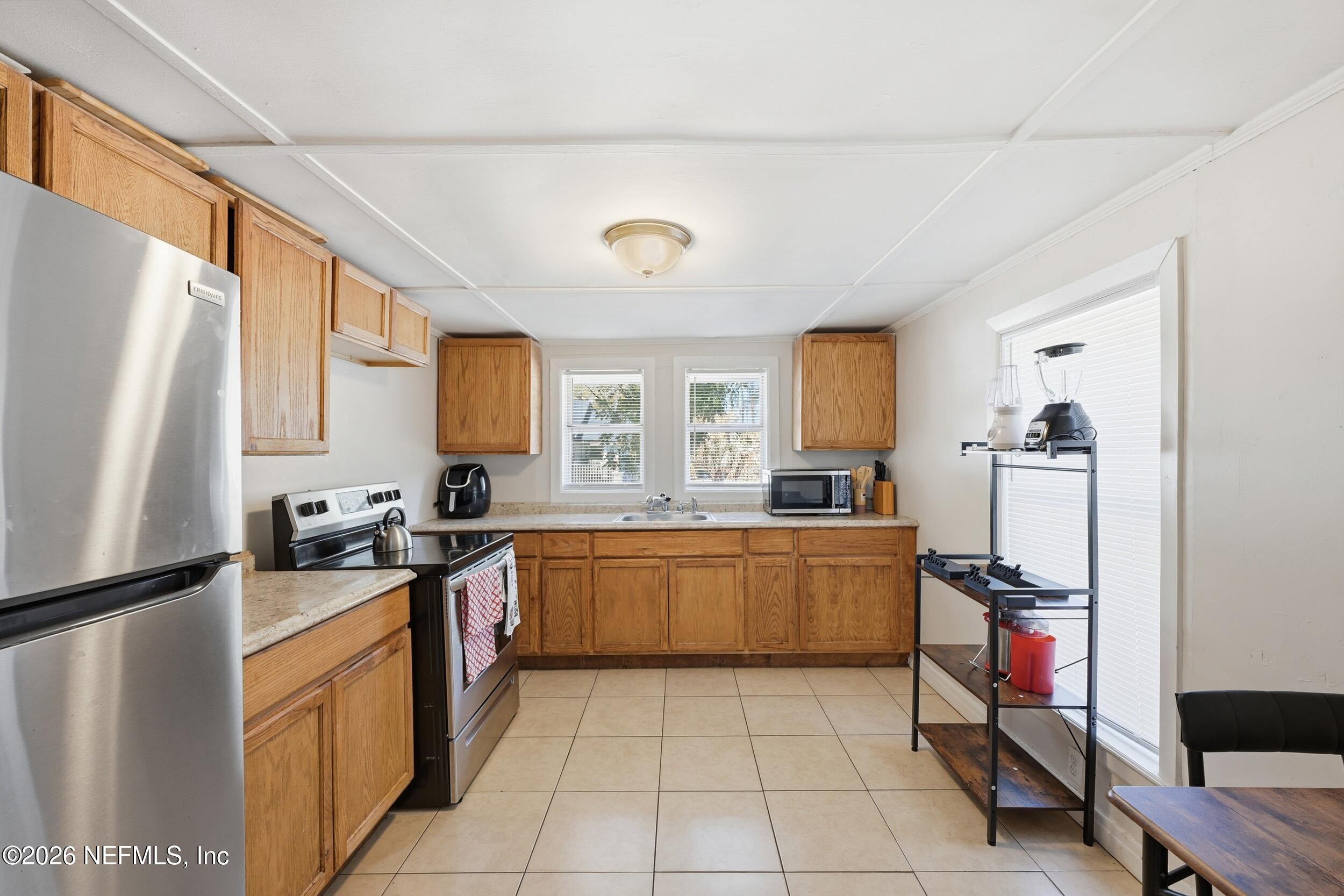 760 Westbrook Road Jacksonville, FL 32209 - Photo 4 of 11 a kitchen with stainless steel appliances granite countertop a sink stove and refrigerator