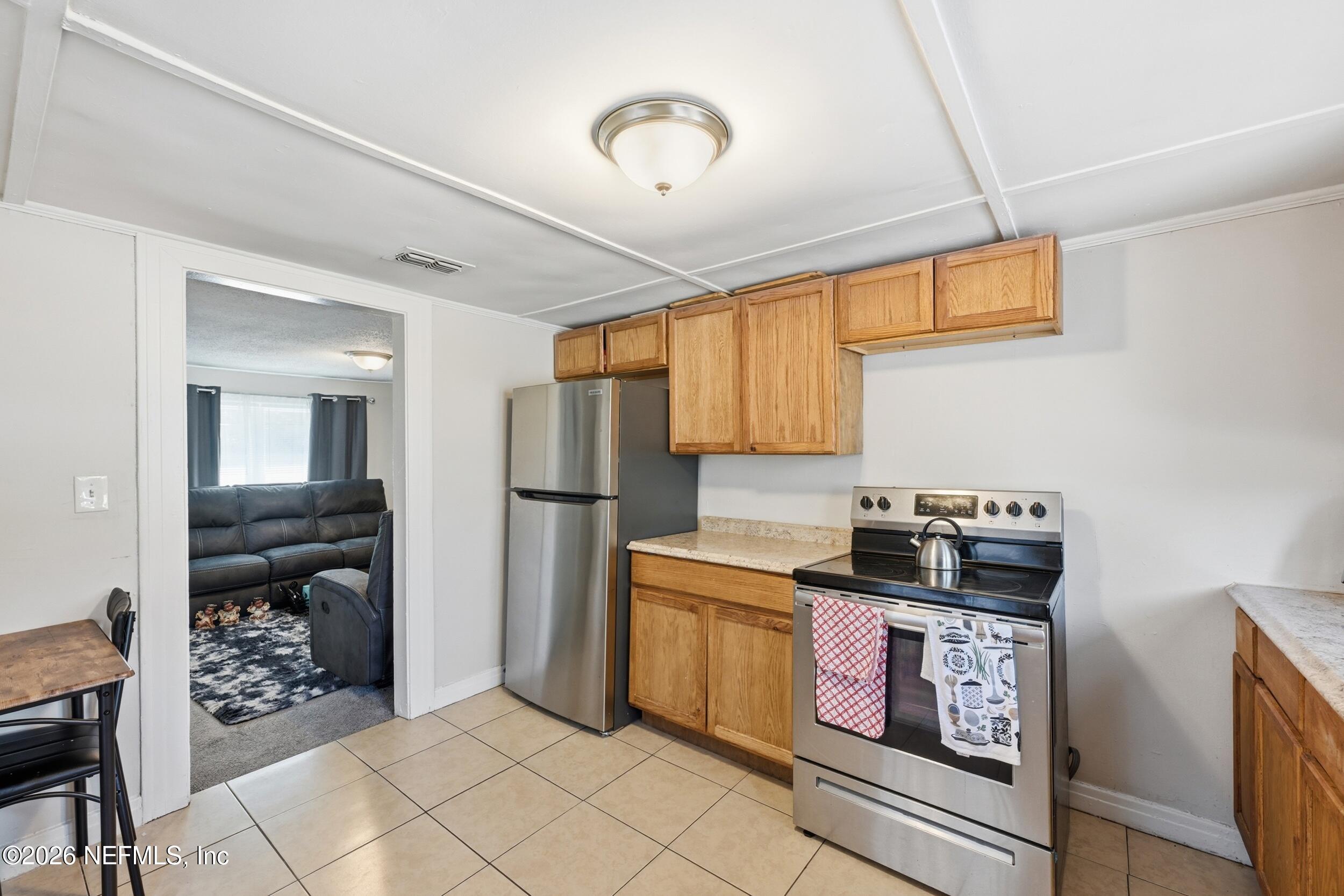 760 Westbrook Road Jacksonville, FL 32209 - Photo 5 of 11 a kitchen with stainless steel appliances granite countertop a stove a sink and a refrigerator