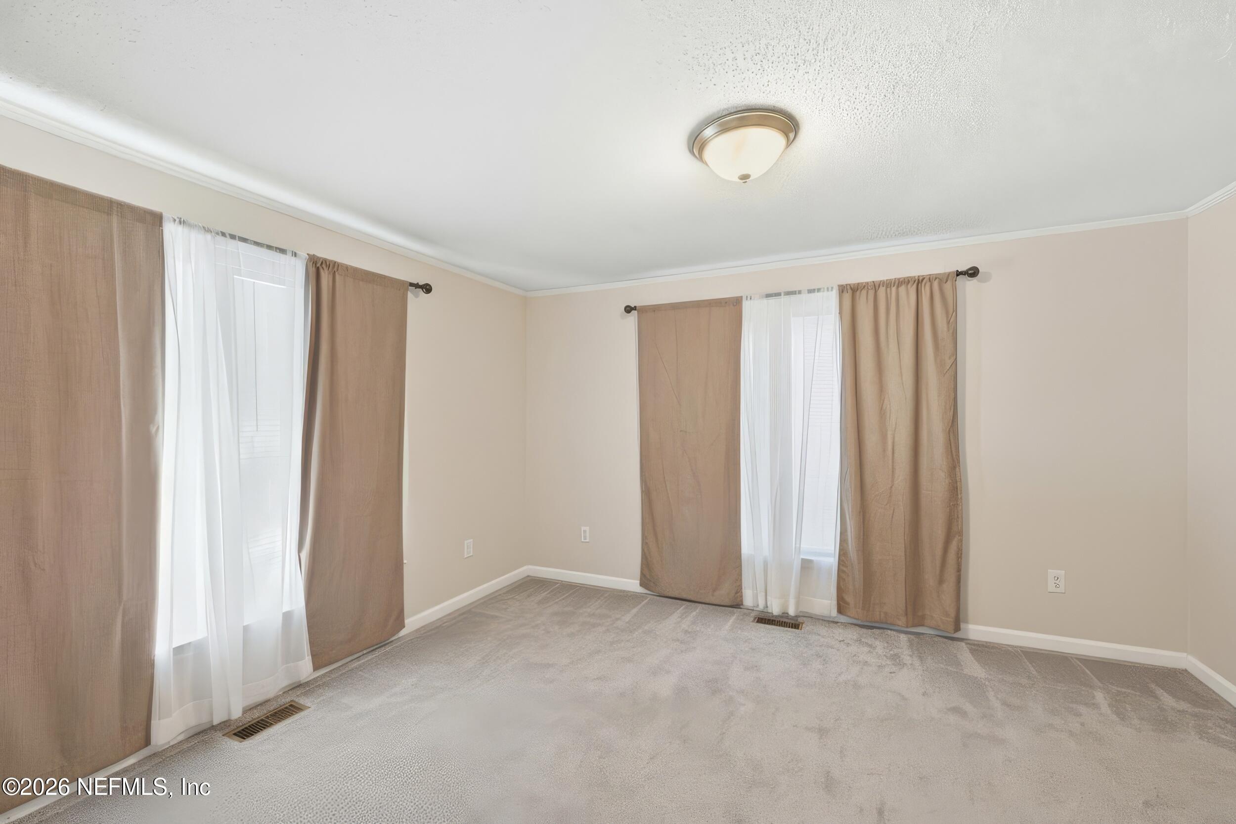 760 Westbrook Road Jacksonville, FL 32209 - Photo 7 of 11 an empty room with windows