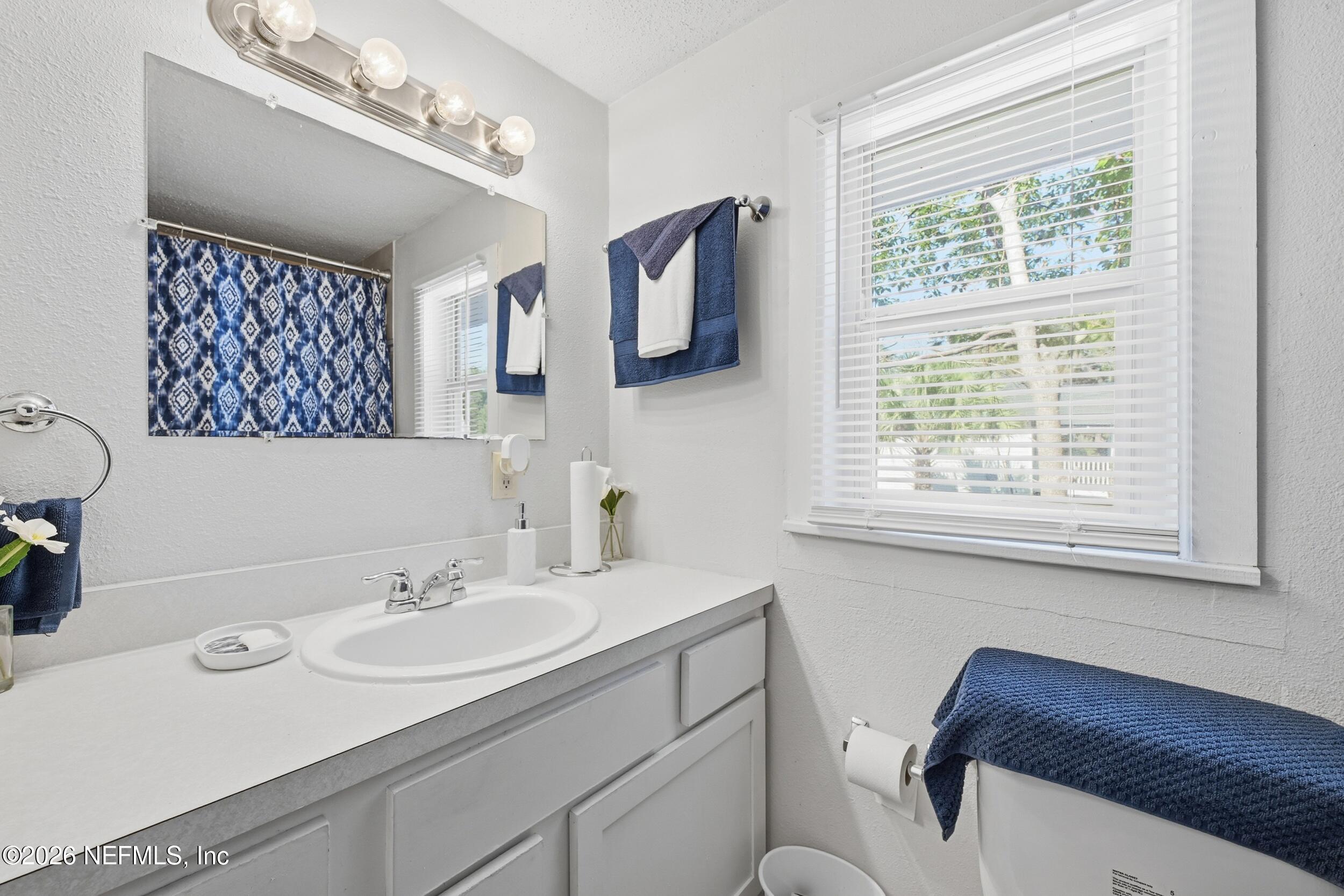 760 Westbrook Road Jacksonville, FL 32209 - Photo 8 of 11 a bathroom with a sink and a mirror
