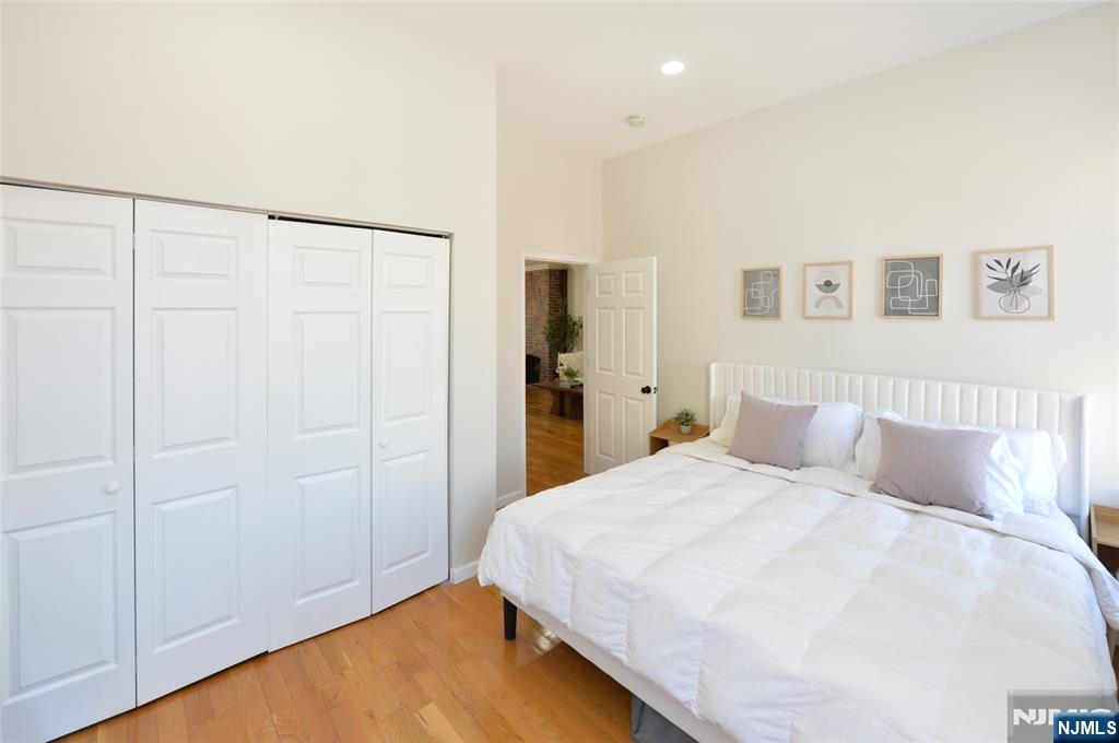 209 Adams Street, Unit 5 Hoboken, NJ 07030 - Photo 12 of 15 a bedroom with a bed and a closet