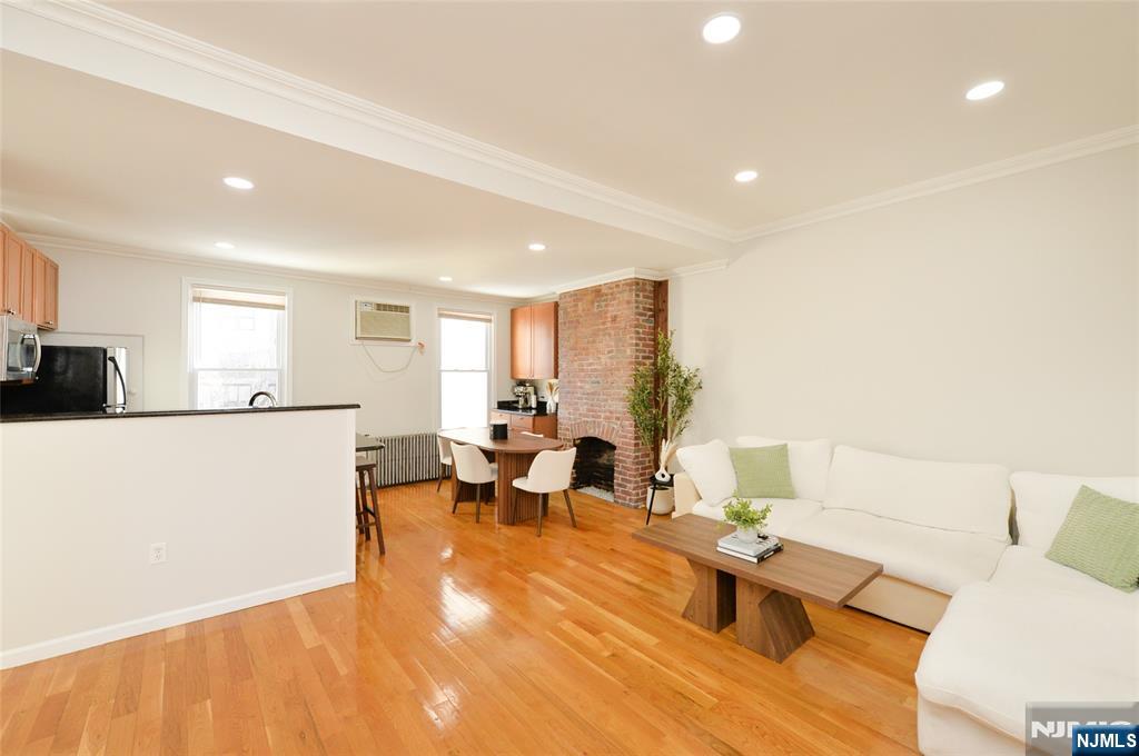209 Adams Street, Unit 5 Hoboken, NJ 07030 - Photo 3 of 15 a living room with furniture and a table