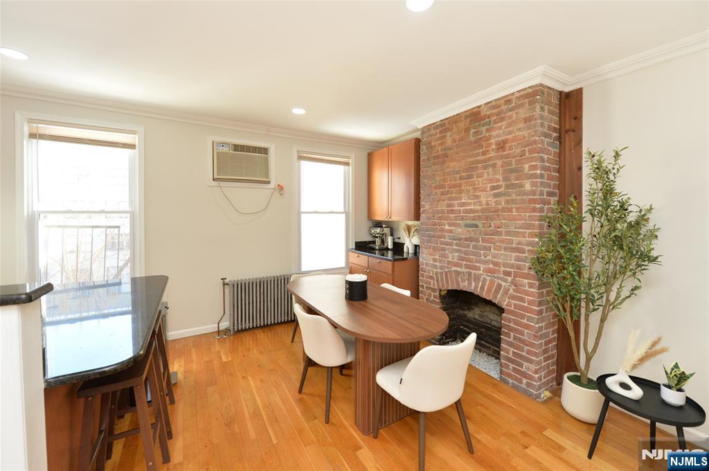 209 Adams Street, Unit 5 Hoboken, NJ 07030 - Photo 10 of 15 a dining room with furniture and wooden floor