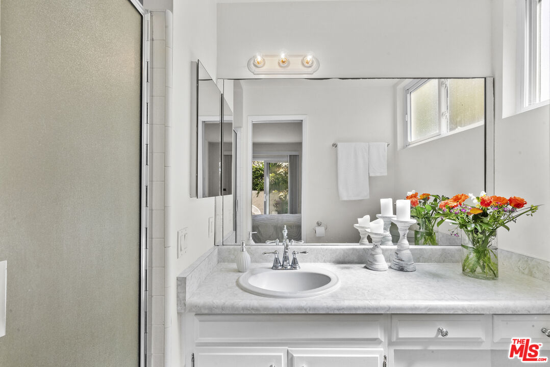 28366 Rey De Copas Lane Malibu, CA 90265 - Photo 13 of 20 a bathroom with a sink a vanity and a mirror