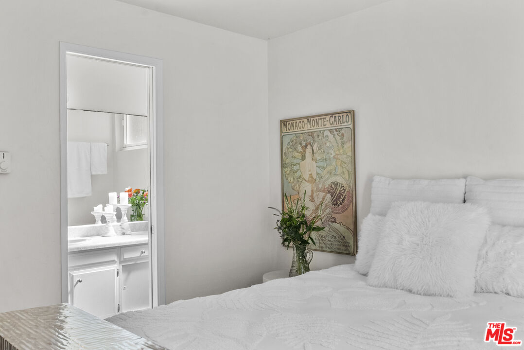 28366 Rey De Copas Lane Malibu, CA 90265 - Photo 14 of 20 a bedroom with a bed and a potted plant