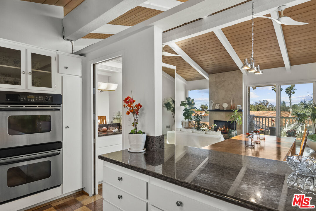 28366 Rey De Copas Lane Malibu, CA 90265 - Photo 7 of 20 a kitchen with stainless steel appliances granite countertop a stove a sink and a cabinets