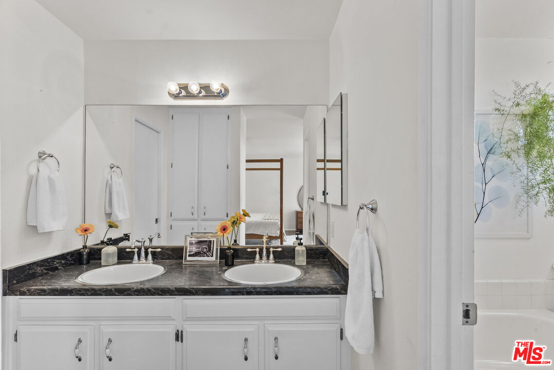 28366 Rey De Copas Lane Malibu, CA 90265 - Photo 10 of 20 a bathroom with double vanity sinks a vanity and a mirror