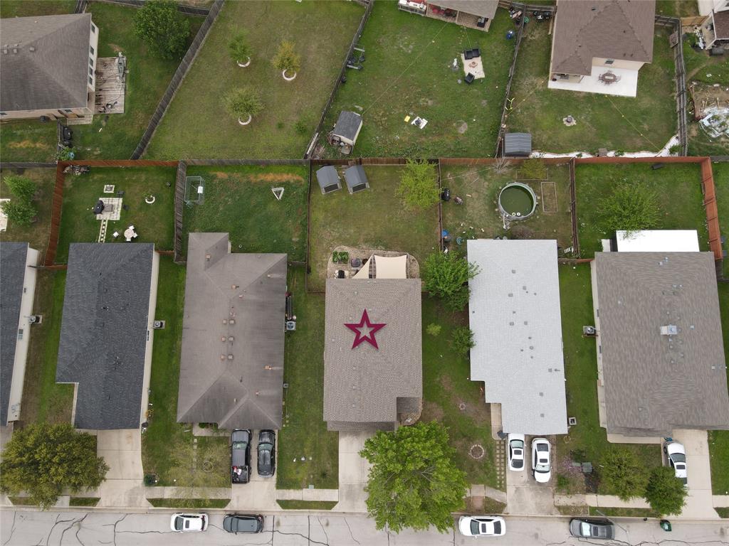 18021 Prairie Verbena Lane Elgin, TX 78621 - Photo 30 of 33 An aerial perspective reveals the neighborhood layout, showcasing fenced backyards and residential streets.
