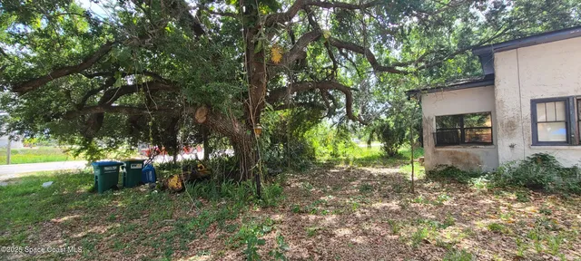 a backyard of a house with lots of green space