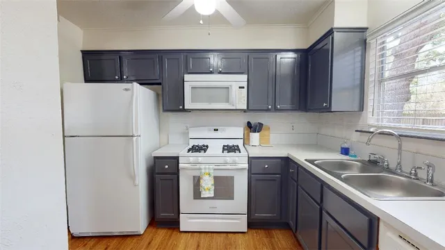 a kitchen with a refrigerator sink and microwave