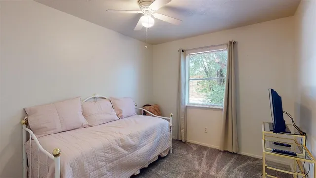 a bedroom with a large bed and a flat tv screen on a dresser