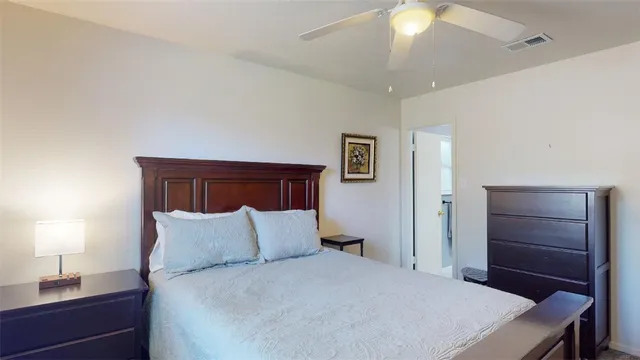 a bedroom with a bed and a lamp