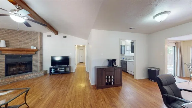 a living room with furniture a fireplace and a flat screen tv