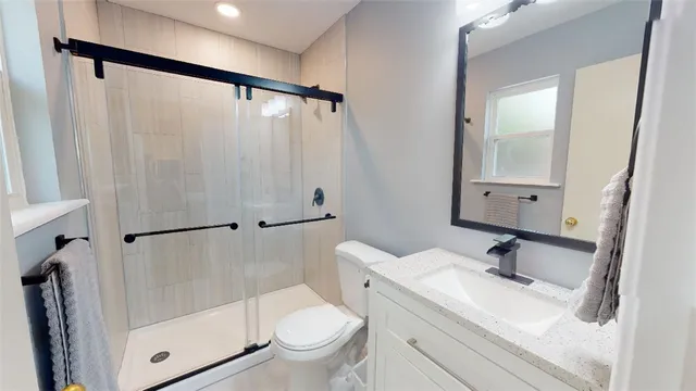 a bathroom with a sink toilet and shower