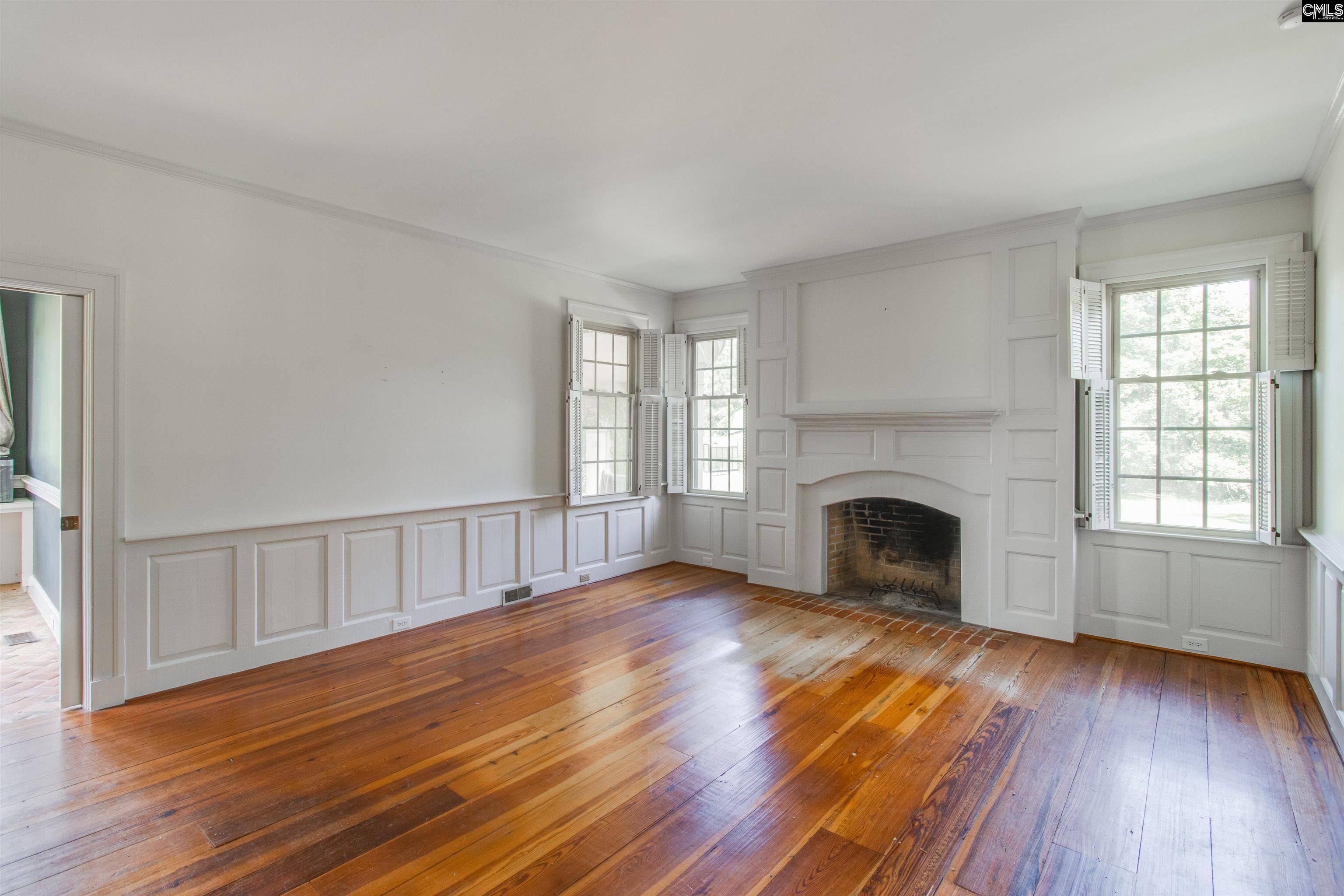 701 Longtown Road Columbia, SC 29229 - Photo 14 of 26 a view of empty room with wooden floor and fireplace