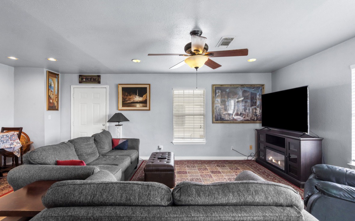 620 6th Street Dickinson, TX 77539 - Photo 12 of 36 a living room with furniture and a flat screen tv