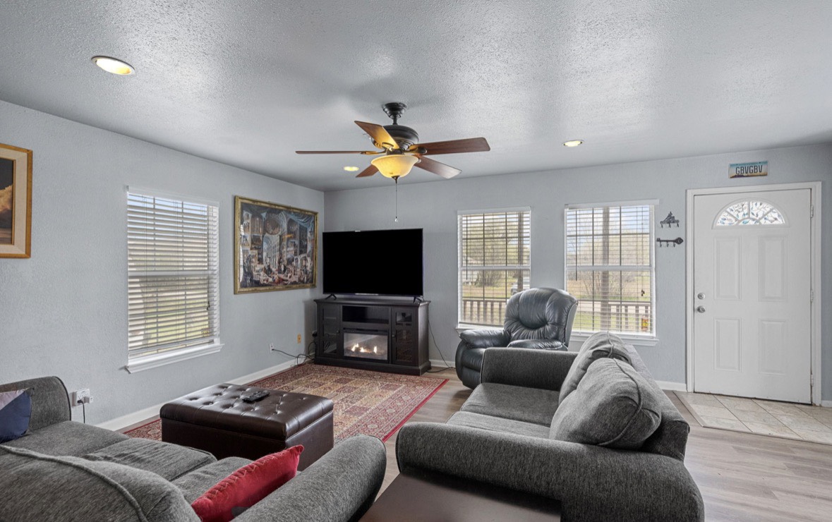 620 6th Street Dickinson, TX 77539 - Photo 14 of 36 a living room with furniture a window and a flat screen tv