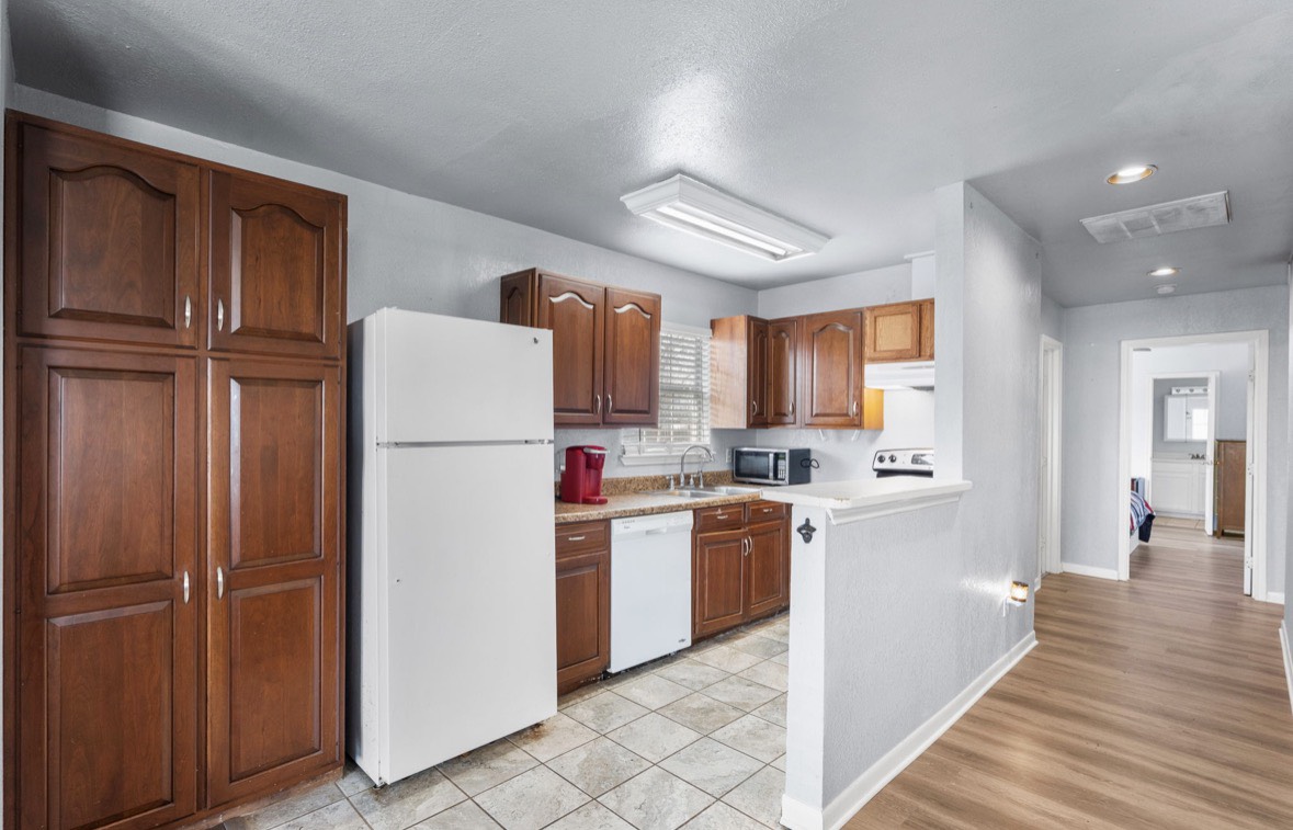 620 6th Street Dickinson, TX 77539 - Photo 18 of 36 a kitchen with stainless steel appliances granite countertop a refrigerator and a stove top oven