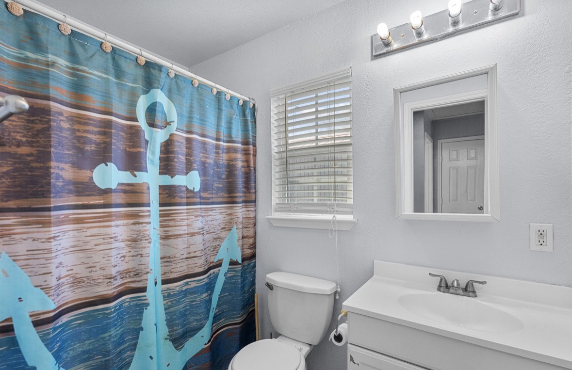 620 6th Street Dickinson, TX 77539 - Photo 21 of 36 a bathroom with a toilet and a sink